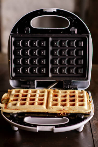 istock Cooking waffles stuffed with sausage, cheese. Pizza waffle, piffle. 1495408093