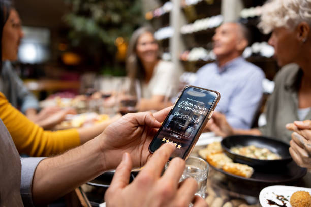 istock Customer at a restaurant rating his experience on a mobile app 1495413484