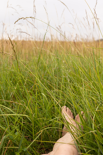 A point of view of an unrecognisable person who is laying down in a field whilst enjoying a getaway to Toulouse in the south of France.