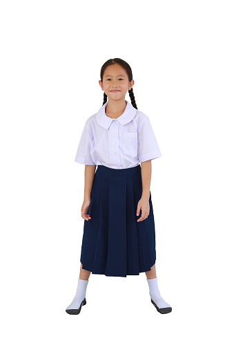 Smiling Asian schoolgirl in thai school uniform standing isolated on white background. Image full length with Clipping path