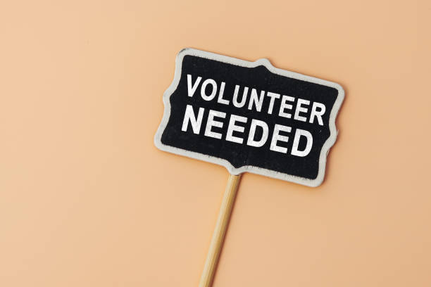 istock VOLUNTEER NEEDED - text on a small chalkboard on a beige background. Top view. Life and business motivational inspirational concept 1495417521