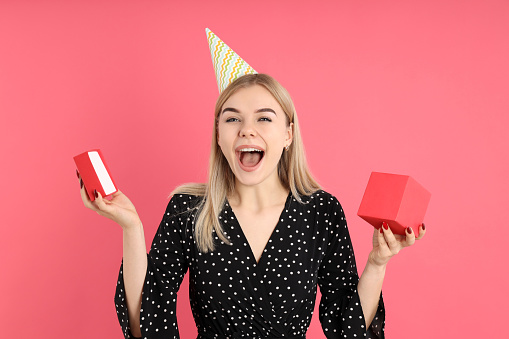 Concept of Happy Birthday with attractive girl on pink background