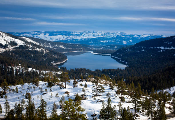 A breathtaking aerial view of Mt. Rose - Ski Tahoe, a popular ski resort in the Sierra Nevada. The snow-covered slopes and dense evergreen forest create a stunning winter landscape, perfect for skiing, snowboarding, and mountain adventures.