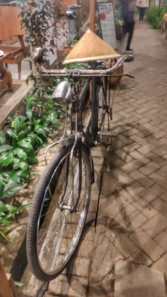 an old bicycle is made into a decoration in the corner of a rustic themed restaurant