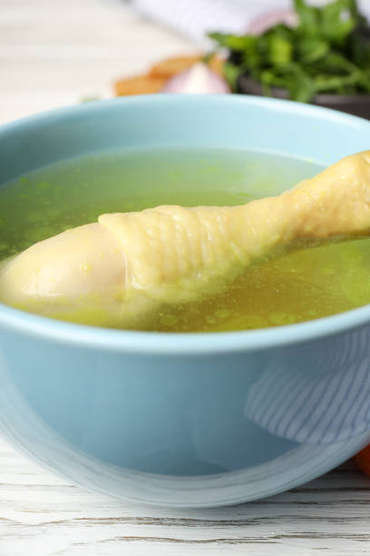istock Chicken soup on white wooden background, close up 1495422510