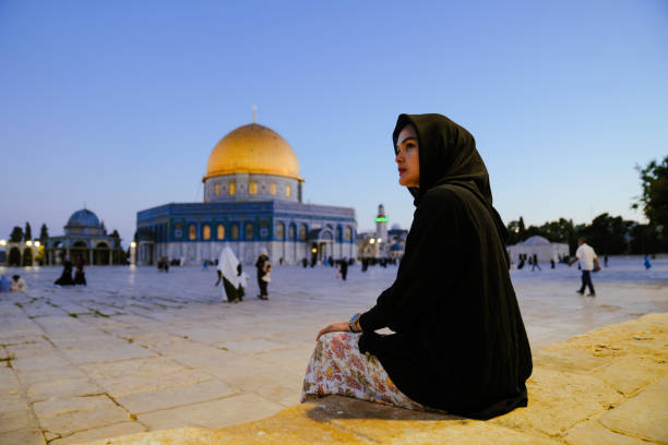 asiatische muslimische frau betet mit felsendom im hintergrund - dome of the rock jerusalem israel arch stock-fotos und bilder