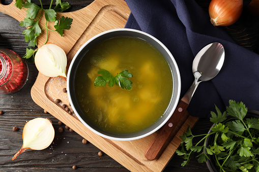 Concept of tasty food with chicken soup on wooden background