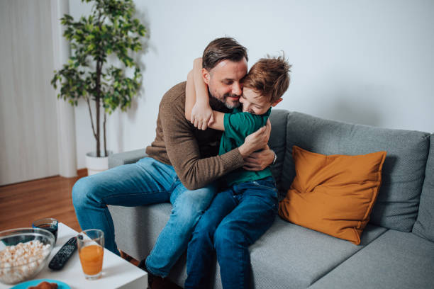 istock Father and Son Find Comfort on the Sofa 1495423614