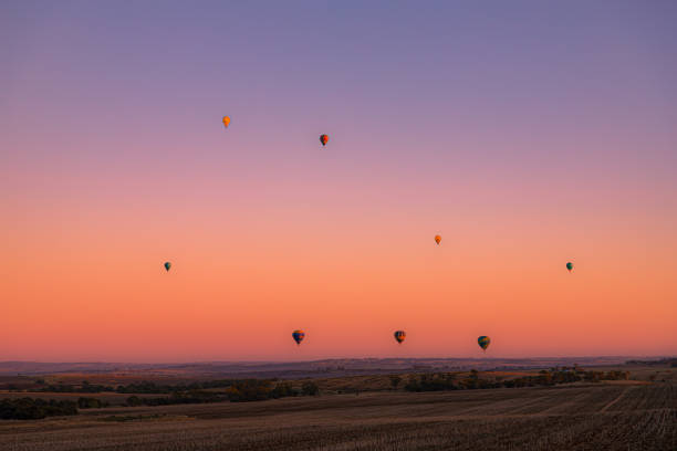 Various country landscape and sky photos populated by hot air baloons.