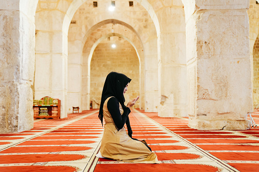 Muslims woman prayer inside of al Aqsa mosque