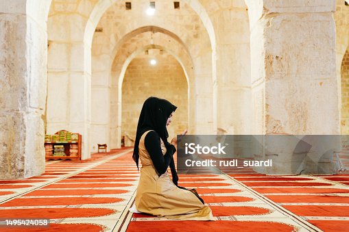 istock Muslims woman prayer inside of al Aqsa mosque 1495424058
