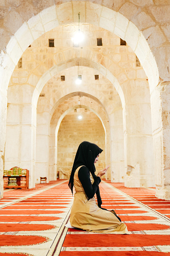 Muslims woman prayer inside of al Aqsa mosque