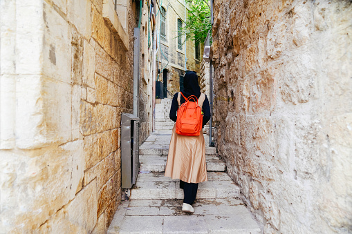 asian muslim woman walking on pedestrian in  the old Jerusalem