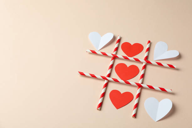 istock Valentine's Day concept with tic tac toe on beige background 1495427524
