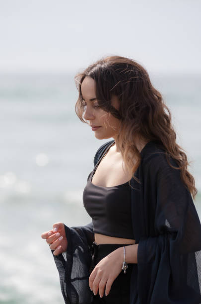 istock Young woman is walking on the sand. 1495429613