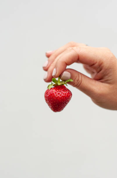 istock sweet red strawberry in the hand 1495430321
