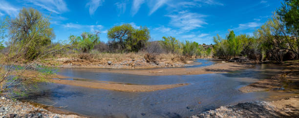 The Agua Fria (Cold Water in Spanish) River is a 120-mile-long tributary of the Gila River in central Arizona.  The headwaters of the river are at Glassford Hill near Prescott in Yavapai County.  The river flows through the desert landscape of Agua Fria National Monument and ends at Lake Pleasant north of Phoenix.  The river has been a vital water source for thousands of years as well as having significant cultural and historical importance. Indigenous people such as the Hohokam inhabited this region, utilizing the river’s resources for agriculture, hunting, and gathering.  Agua Fria National Monument encompasses 71,100 acres of the Sonoran Desert in central Arizona. President Bill Clinton established the national monument in 2000 to protect the cultural and natural resources of the region.  The monument is managed by the Bureau of Land Management (BLM) and is characterized by its rich cultural heritage and diverse ecosystems. It contains numerous archaeological sites, petroglyphs, and remnants of ancient pueblos, representing thousands of years of Native American history.  This picture of the Agua Fria River was photographed in the Agua Fria National Monument near Cordes Lake, Arizona, USA.