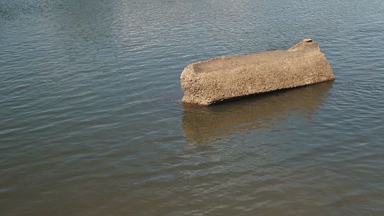 concrete block in the river caused by abrasion