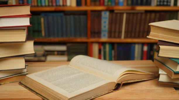 istock Open book, bookshelf with books. The concept of knowledge, libraries. 1495433688