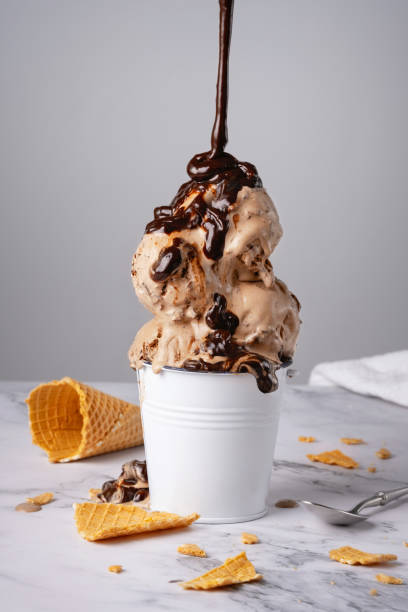 Chocolate ice cream with syrup in a white bucket