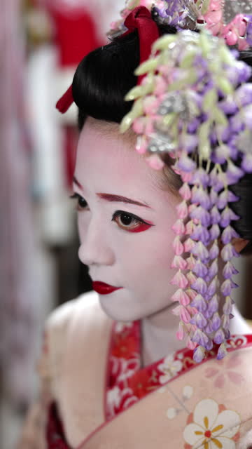 Woman wearing traditional Japanese kimono to have Maiko (Geisha in training) makeover experience in Gion, Kyoto -  high angle view