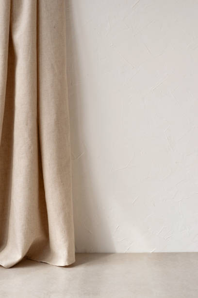 istock Elegant neutral beige empty room design interior, white plaster wall with copy space, linen curtain and beige stone floor, aesthetic home background 1495446027