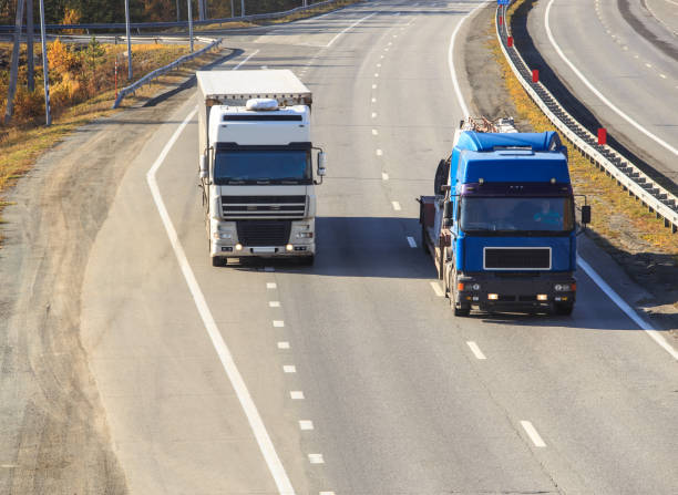 istock Trucks moving on a country road 1495446038