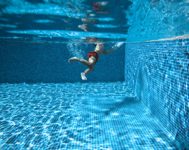 Teenage boy swimming crawl