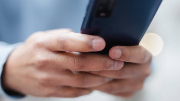 istock man hand holding smart phone 1495448282