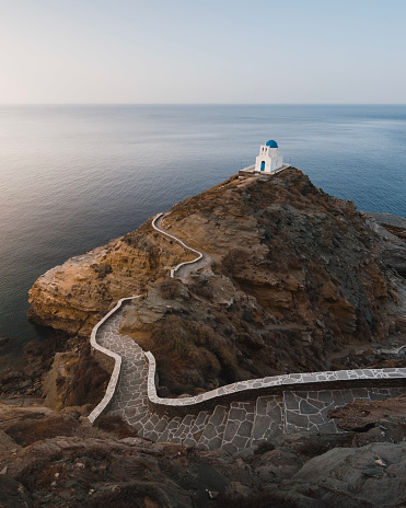 Nice view of the Kastro church on top of a cliff surrounded by the sea and with a twisty access path. On the Greek island of Sifnos in the Cyclades