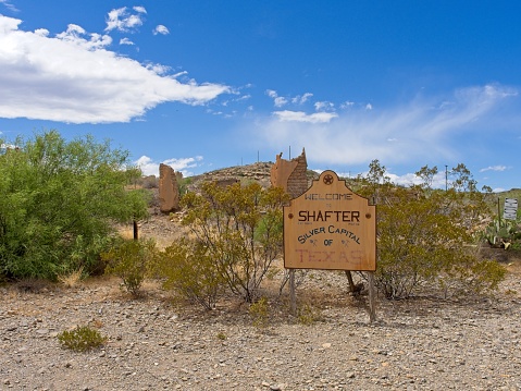 Shafter, Texas - USA, May 4, 2023. Shafter ghost town in west Texas, a brief silver mining boom town in the 1880s. Town sign and crumbling adobe structures.