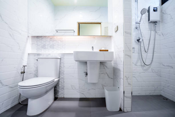 istock white bathroom interior with a shower, a toilet and a sink 1495453343