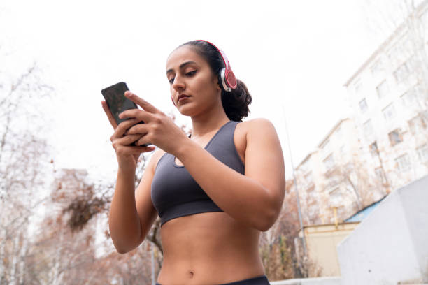 istock Woman using a smartphone and headphones after workout 1495454820