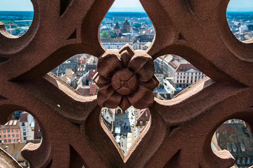 Aerial view of Strasbourg old town, with architectural detail of the cathedral tower in the foreground, Alsace, France