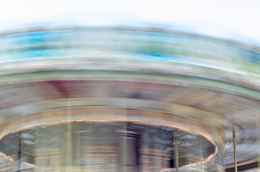 Carousel spinning at high speed, colorful background