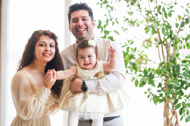 istock little girl having fun in her parents' lap 1495465855