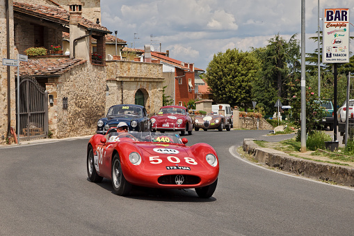vintage racing car Maserati 200 SI (1957) runs in Tuscan village in classic car race Mille Miglia, on May 17, 2014 in Colle di Val d'Elsa, Tuscany, Italy