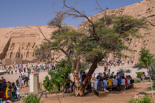 Nubia, Egypt - April 27, 2023: Lot of people around the temples of Ramses II and Nefertari in Abu Simbel