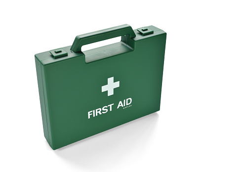 Close up of green first aid kit box isolated on white background, selective focus.