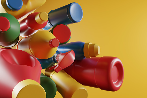 Bunch of colorful plastic bottles on bright yellow background. Illustration of the concept of plastic water bottle pollution