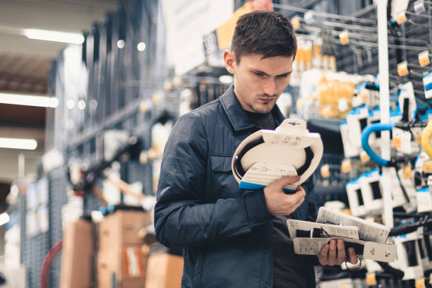 istock A young man inspects goods in a store. 1495482935