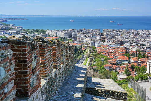 Thessaloniki in Greece, aerial panoramic view from Ani Poli, the upper old town with historic city walls over the modern center and the coast of the Mediterranean Sea on a sunny day, copy space