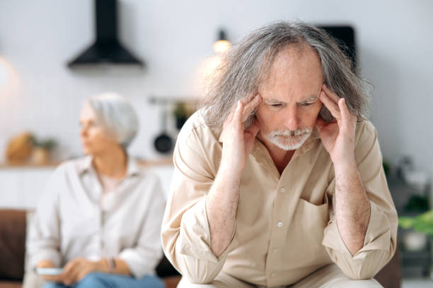 istock Mature caucasian spouses misunderstanding each other, experiencing crisis in relationship, offended husband looks away disappointedly, the wife sits in defocus on a background. Quarrel, marital crisis 1495486137