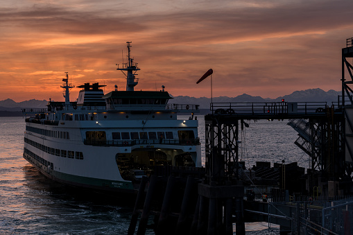 Seattle, USA - Mar 16, 2023: Elliott Bay late in the day as a Ferry approaches the Colman dock at Sunset.