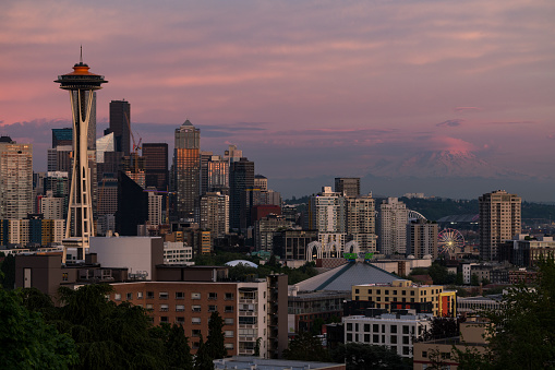 Seattle, USA - May 16, 2023: The Puget Sound Seattle skyline at sunset with Mt Rainier.