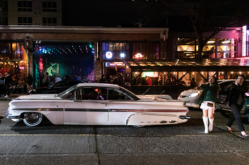 Seattle, USA - Apr 14th, 2023: Lowrider car club on Pike Street on Capitol Hill late in the evening.