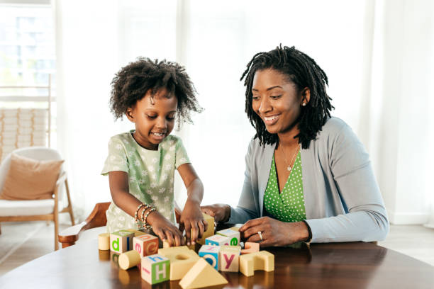 istock Learning moments, mom and kid playing together with wooden blocks 1495495751