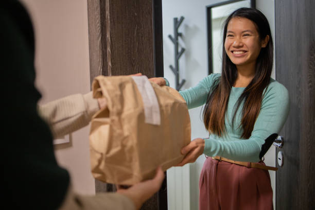 istock Courier delivering fast food to the customer 1495500671