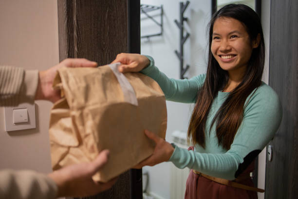 istock Courier delivering fast food to the customer 1495500676