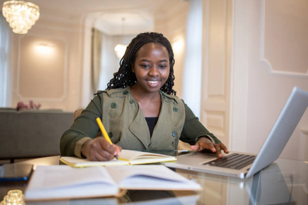 istock Young fashionable woman working at home 1495500751